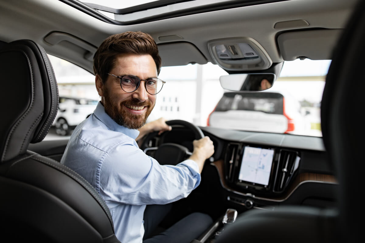 smiling businessman sitting inside car at dealersh 2024 07 12 00 40 46 utc